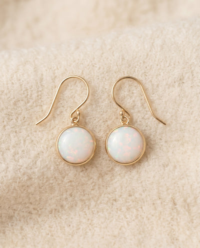 By Sophi Vintage Opal Stone Gold Earrings flat-lay on warm cream