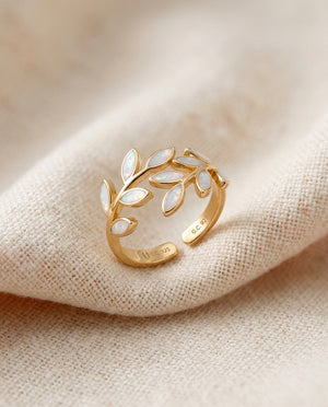 White opal leaf adjustable ring in gold on cream textile, olive-branch laurel design