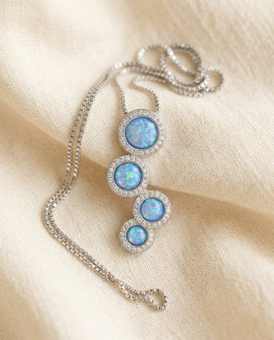 By Sophi Zircon and Opal Silver Necklace flat-lay on warm cream