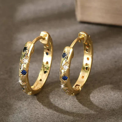 Vintage gold hoop earrings with deep blue front accent. By Sophi.