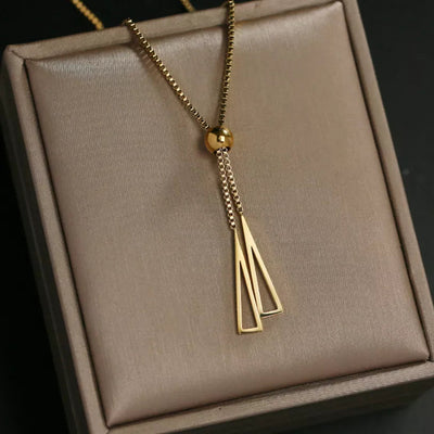 Long gold-toned chain ending in a slim tassel pendant. By Sophi.