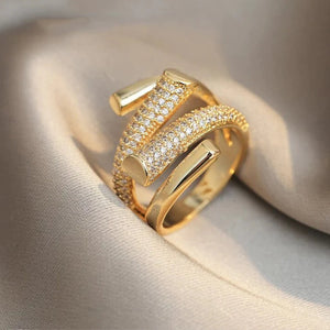 Zirconia ring with stones set across the band, gold tone. By Sophi.