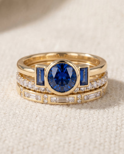 By Sophi Vintage Elegant Blue Zirconia Ring Set flat-lay on warm cream
