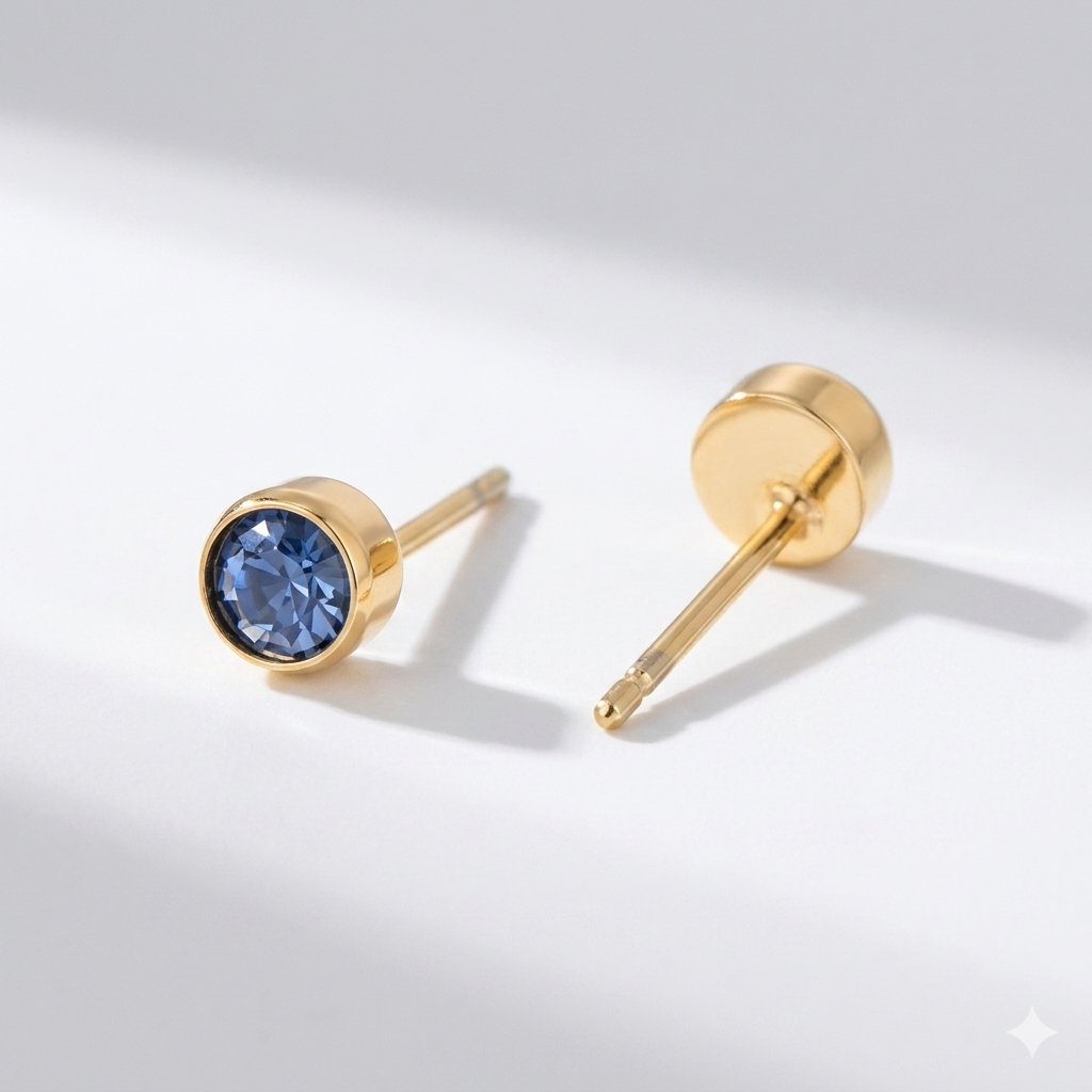 Montana sapphire birthstone stud earrings in gold-toned bezel. By Sophi.