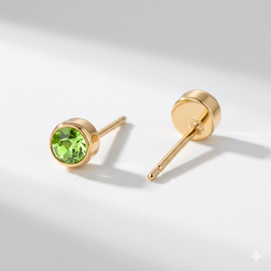 Peridot birthstone stud earrings in gold-toned bezel. By Sophi.