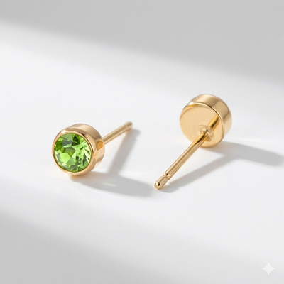 Peridot birthstone stud earrings in gold-toned bezel. By Sophi.