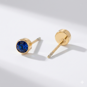 Sapphire birthstone stud earrings in gold-toned bezel. By Sophi.
