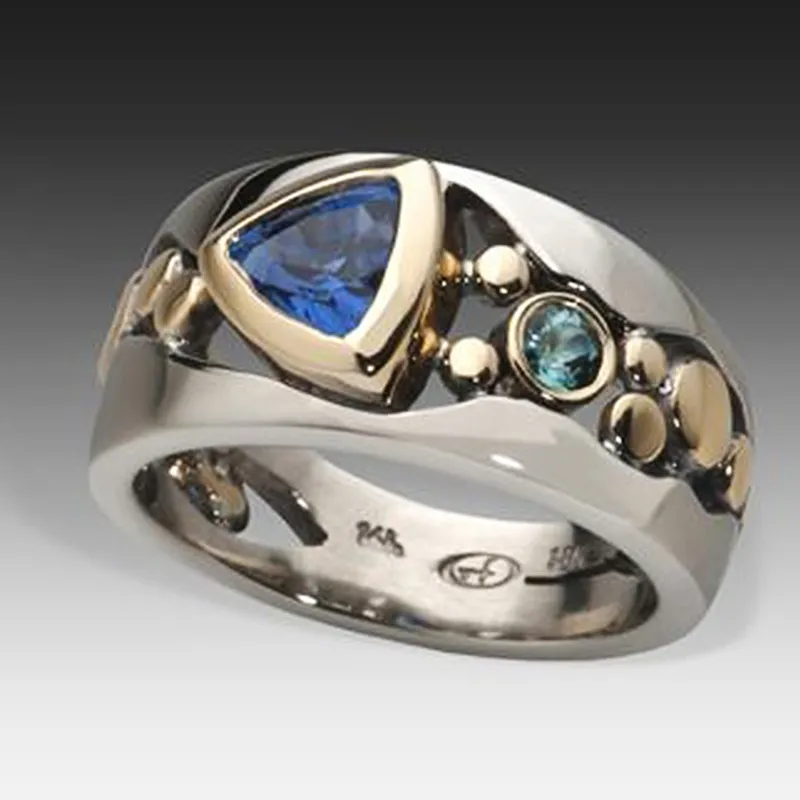 Silver ring with blue gemstone on a gradient background