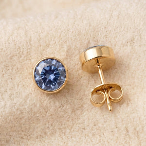By Sophi Montana Sapphire Birthstone Studs flat-lay on warm cream wool