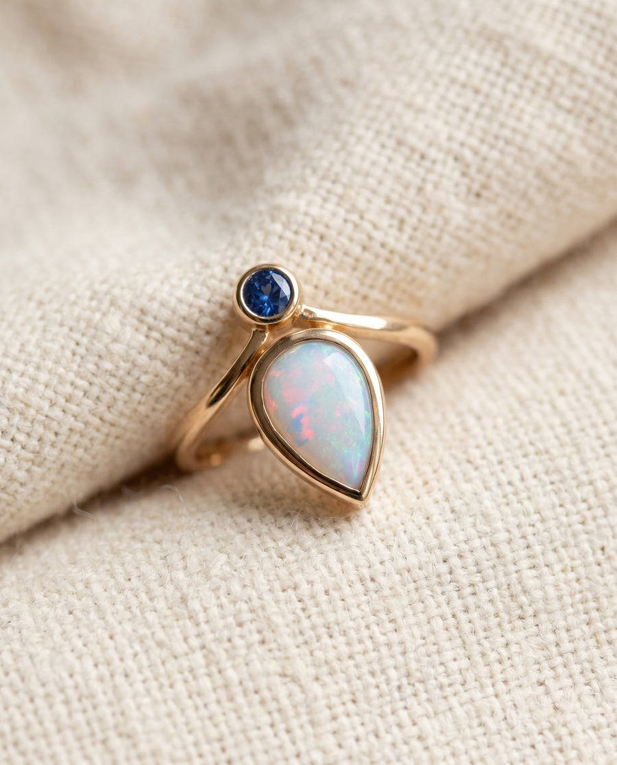 By Sophi Vintage Blue Opal Ring in Gold flat-lay on warm cream